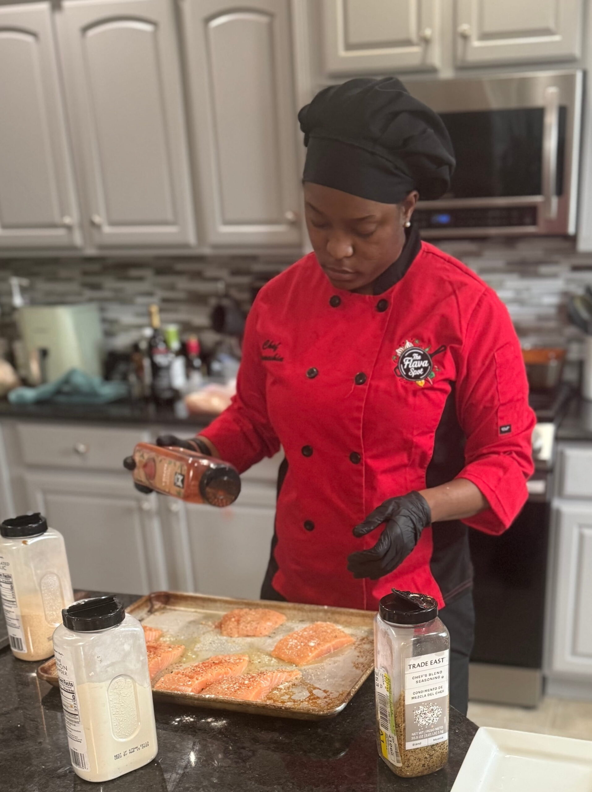 Chef Jameshia preparing an elegant dish by The Flava Spot